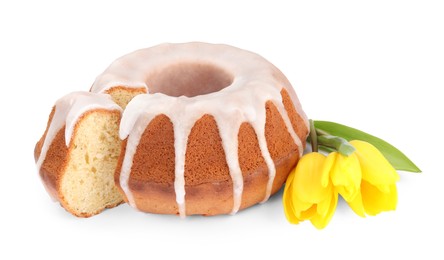 Photo of Traditional Easter cake and yellow tulips on white background