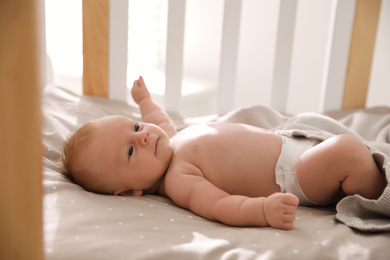 Cute little child lying in cot. Healthy baby
