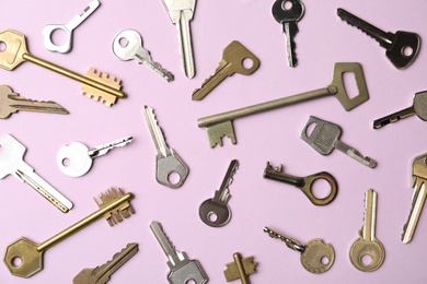 Steel keys on pink background, flat lay. Safety concept