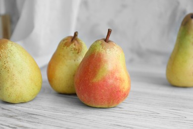 Juicy pears and double-sided backdrop on table in photo studio
