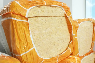 Photo of Packages of thermal insulation material indoors, closeup