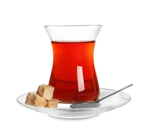 Photo of Glass of traditional Turkish tea with sugar cubes and spoon isolated on white