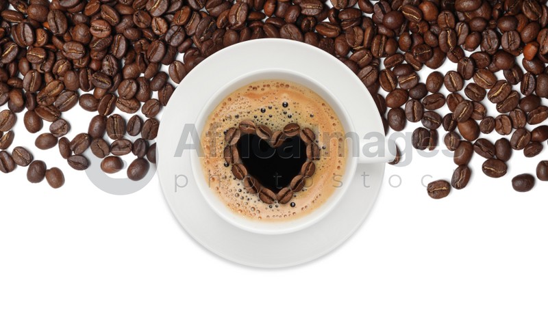 Image of Cup of tasty coffee and roasted beans on white background, top view
