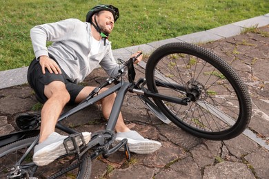 Photo of Man fallen off his bicycle in park