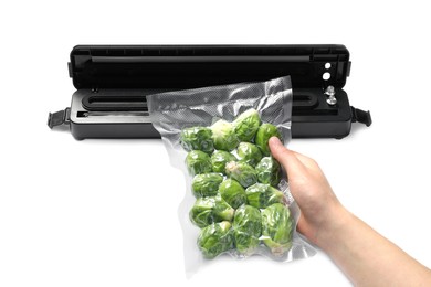 Woman with vacuum pack of Brussels sprouts on white background, closeup