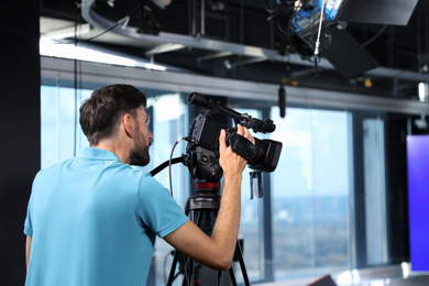 Professional video camera operator working in studio