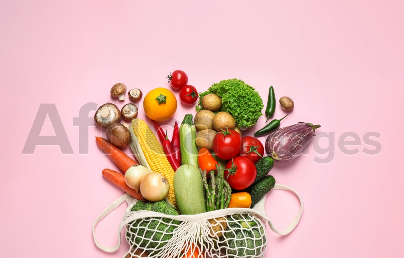 Photo of Different fresh vegetables on pink background, flat lay