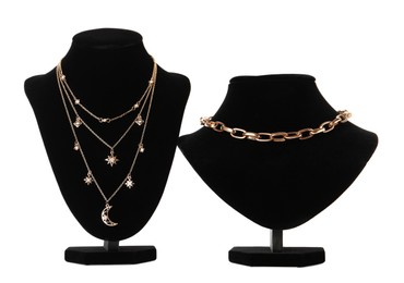 Stylish necklaces on jewelry busts against white background