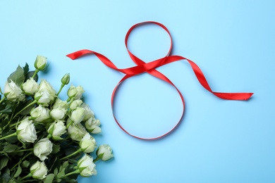 8 March greeting card design with red ribbon and roses on light blue background, flat lay. International Women's day