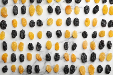 Flat lay composition with raisins on marble background. Dried fruit as healthy snack