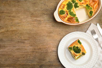 Tasty broccoli casserole served on wooden table, flat lay. Space for text