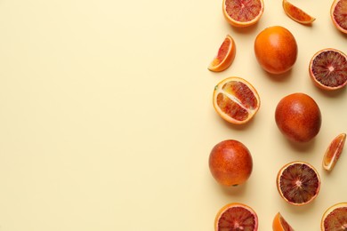 Many ripe sicilian oranges on beige background, flat lay. Space for text