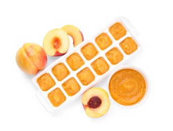 Nectarine puree in ice cube tray and fresh nectarine fruits isolated on white, top view. Ready for freezing