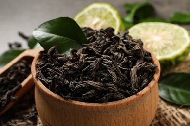 Dry bergamot tea leaves in wooden bowl, closeup