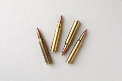 Brass bullets on white background, flat lay