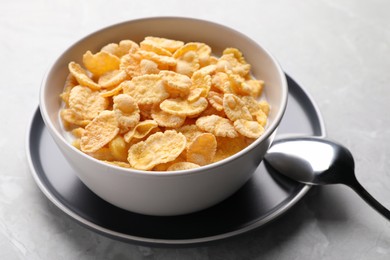 Tasty cornflakes with milk served light grey table