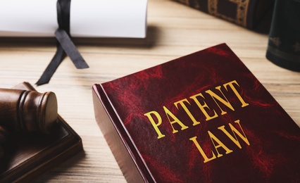 Patent Law book on wooden table, closeup 
