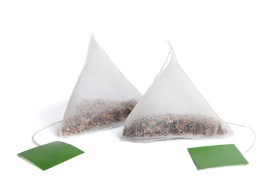 Paper tea bags with tags on white background