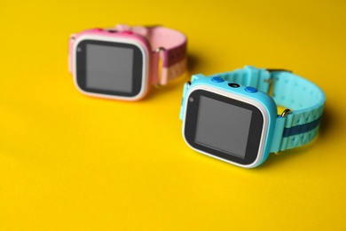 Modern trendy smart watches for kids on yellow background