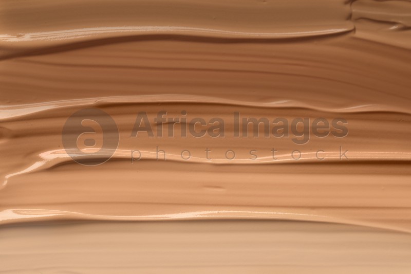 Different shades of liquid foundation as background, closeup