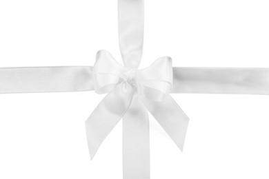 Satin ribbons with bow on white background, top view