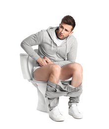 Man suffering from diarrhea on toilet bowl, white background