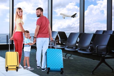 Happy family with suitcases in airport terminal