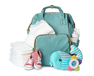 Backpack with disposable diapers and child's accessories on white background