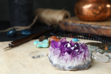 Beautiful amethyst and different gemstones on table