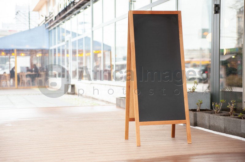Empty A-board near building outdoors. Mockup for design