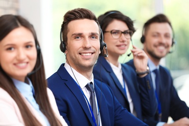Technical support operators with headsets at workplace