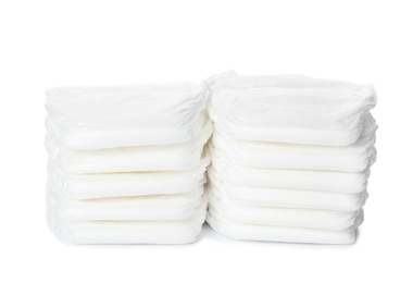 Photo of Stacks of baby diapers isolated on white