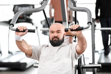 Overweight man training in gym