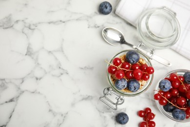 Delicious yogurt parfait with fresh berries on white marble table, flat lay. Space for text