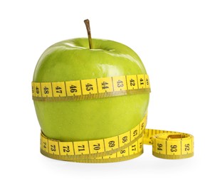 Fresh green apple with measuring tape on white background