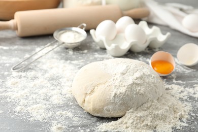 Photo of Wheat dough and products on grey table. Cooking pastries