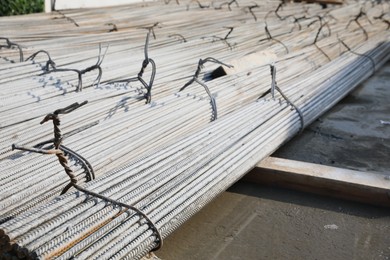 Photo of Many steel reinforcing bars on construction site