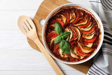 Photo of Delicious ratatouille on white wooden table, top view