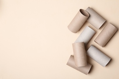Flat lay composition with empty toilet paper rolls and space for text on color background