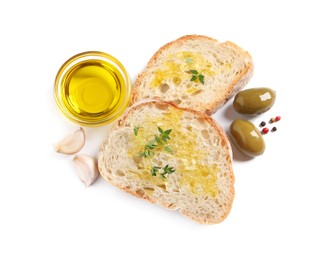 Tasty bruschettas with oil, garlic and olives on white background, top view