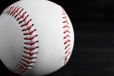 Photo of Baseball ball on black background, closeup with space for text. Sports game