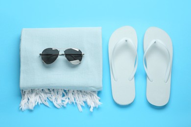 Photo of Flat lay composition with different beach objects on light blue background