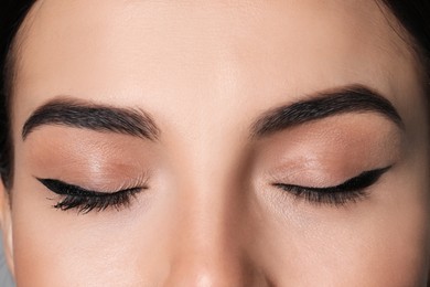 Photo of Beautiful woman with black eyeliner, closeup view