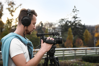 Video operator with professional camera working outdoors