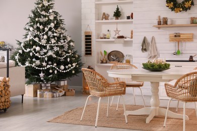 Cozy dining room interior with Christmas tree and festive decor