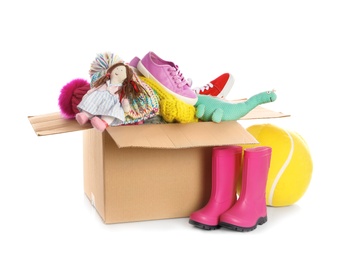 Donation box, shoes, clothes and toys on white background. Space for text