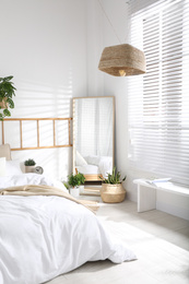 Modern bedroom interior with stylish large mirror