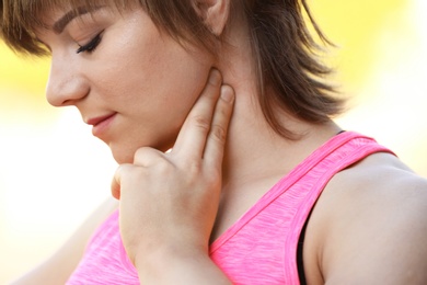 Photo of Young woman checking pulse after workout, closeup