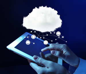 Cloud computing and storage concept. Woman using tablet on dark background, closeup