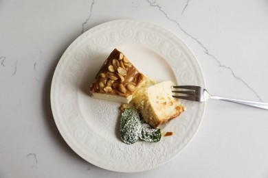 Tasty dessert and fork on white marble table, top view